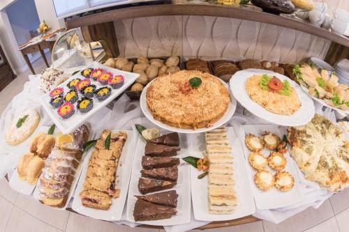 a table topped with lots of different types of food at Hotel Gramado Interlaken in Gramado