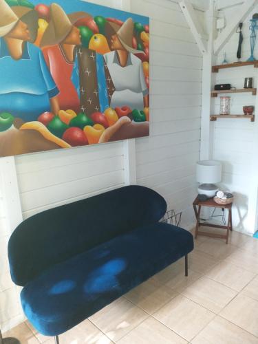 a couch in a room with a painting on the wall at Kaz'bouchons in Saint-François