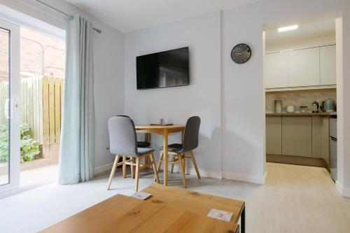 a kitchen and dining room with a table and chairs at Crewe Short Lets 1 Victoria Court, Crewe in Crewe