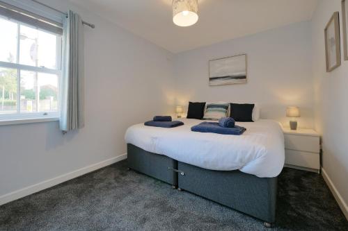 a bedroom with a large bed with two towels on it at Crewe Short Lets 1 Victoria Court, Crewe in Crewe