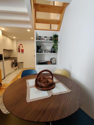 a wooden table with a bowl on top of it at Cais de Gaia Historic Loft in Vila Nova de Gaia