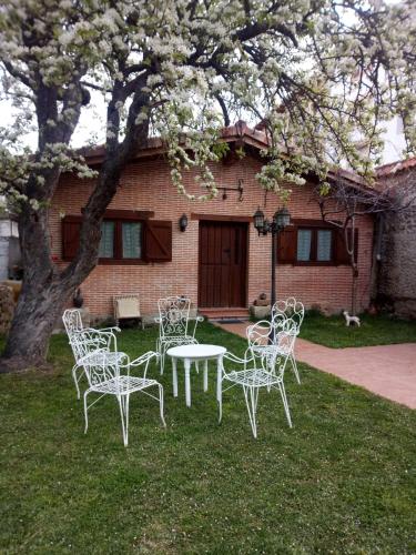 eine Gruppe von Stühlen und einem Tisch vor einem Haus in der Unterkunft Algarabiastayingcristeta in Medina de Pomar