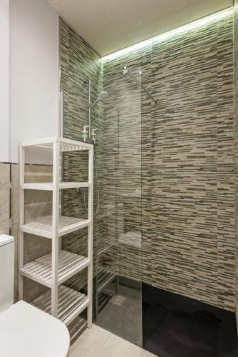 a bathroom with a shower with a glass door at Charming loft B in Málaga