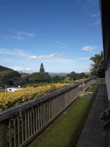 a view of a garden from a balcony at Whatuwhiwhi TOP 10 Holiday Park in Tokerau Beach