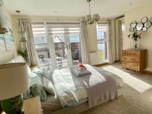 a bedroom with a bed and a large window at Waterfront Villa Marina SA1 Swansea in Swansea