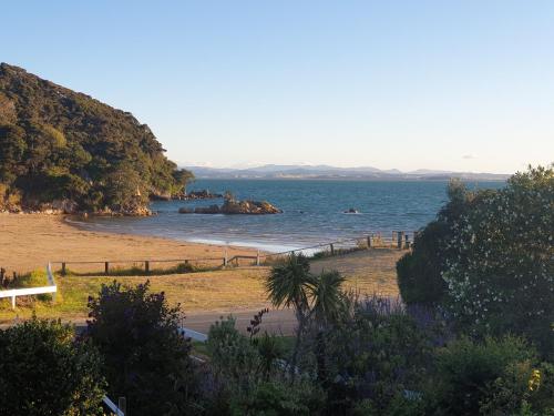 a view of a beach with a body of water at Whatuwhiwhi TOP 10 Holiday Park in Tokerau Beach