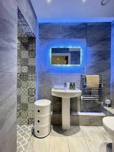 a bathroom with a sink and a mirror at Waterfront Villa Marina SA1 Swansea in Swansea