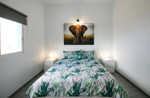 ein Schlafzimmer mit einem Bett und einem Bild eines Elefanten in der Unterkunft Casa Salazar in Fuencaliente de la Palma