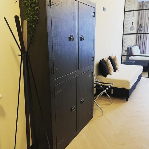 a bedroom with a large cabinet and a bed at Haarlem Apart Hotel in Haarlem
