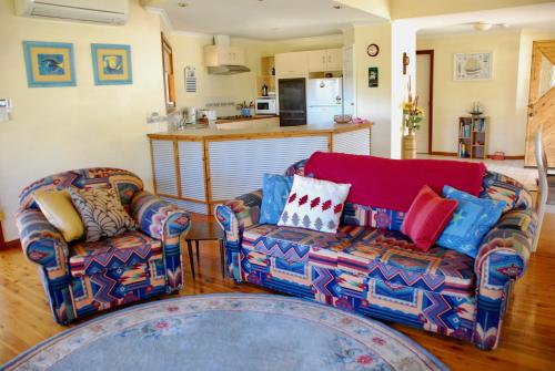 a living room with two chairs and a couch at Annie's Balquhidder Cottage in Victor Harbor
