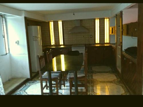 a kitchen with a table and chairs in a room at T&A RESIDENCE Aeropuerto Ezeiza in Monte Grande