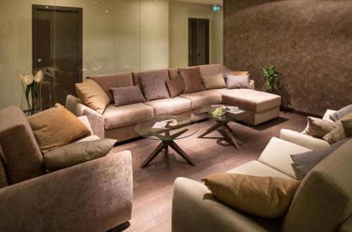 a living room with a couch and a table at Kronwell Brasov Hotel in Braşov