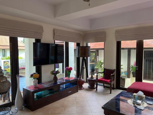 a living room with a flat screen tv and a fish tank at Samui Dreams Seaview Villa - Bangrak Beach - with Private Pool in Koh Samui 