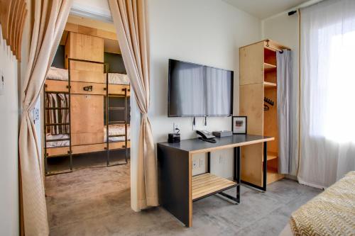 a desk in a room with bunk beds at The Monterey Motel in Albuquerque