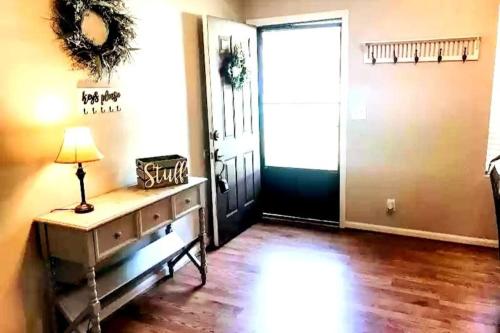 a room with a door and a table with a lamp at GSRealty in Americus