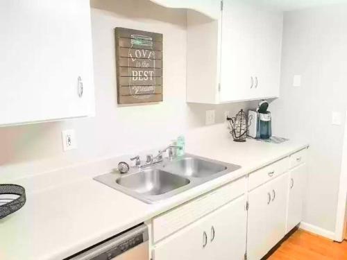 a kitchen with a sink and white cabinets at GSRealty in Americus