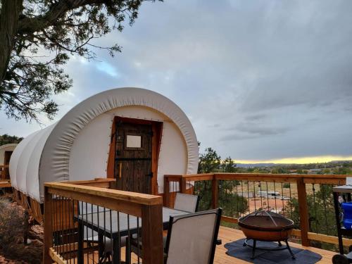 a circular dome house on a deck with a grill at Zion View Camping in Hildale