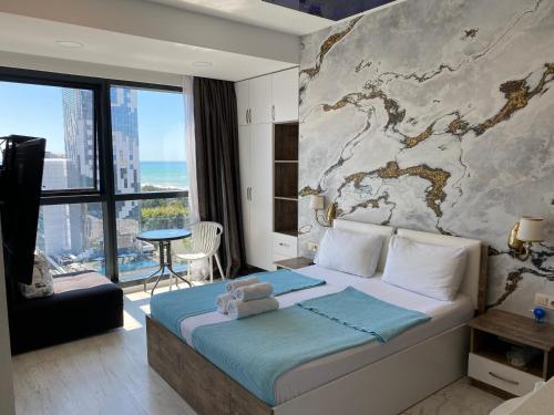 a bedroom with a bed with a map on the wall at Apartment In Porta Batumi Tower in Batumi