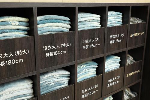 a shelf of towels in a store with writing on them at KAMENOI HOTEL Beppu in Beppu