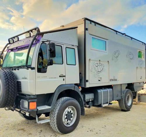 a white truck is parked in the desert at AGRiCAMPiNG POGGiO Ai PiNi WiNE CAMPiNG in Certaldo