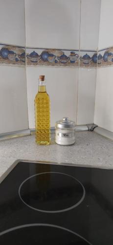 a bottle of yellow oil sitting on a kitchen counter at La Tijera in Candeleda