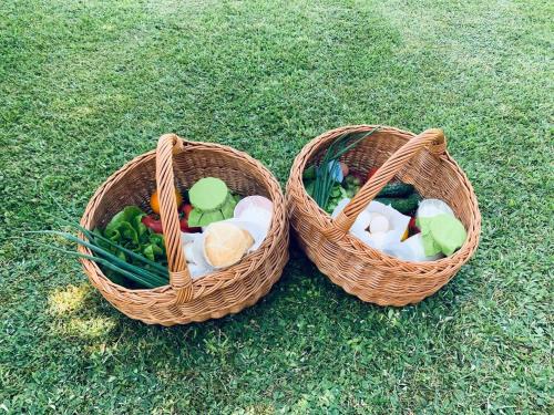 WorytyWarmia Resort的草地上放着两篮装满蔬菜的篮子。