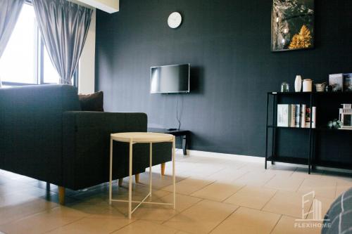 a living room with a couch and a table at 9am-5pm, SAME DAY CHECK IN AND CHECK OUT, Work from Home, Comfy & Quiet Tamarind Suites-Cyberjaya by Flexihome-MY, in Cyberjaya