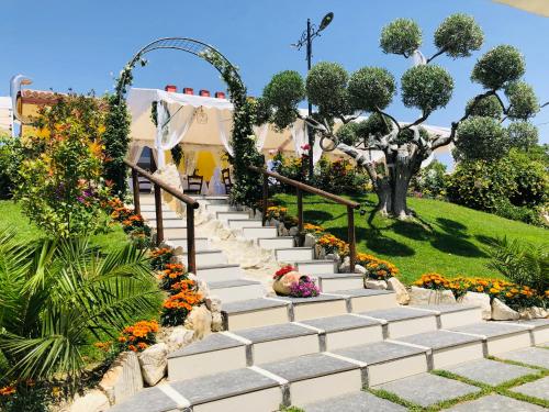 a set of stairs in a garden with flowers at Villa Aurora in Villanova del Battista