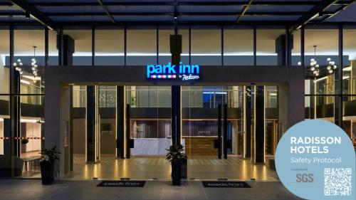 a building with a walkin inn sign in front of it at Park Inn by Radisson Putrajaya in Putrajaya