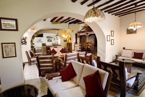 a living room with a couch and a table and chairs at Gattopardo Park Hotel in Lipari