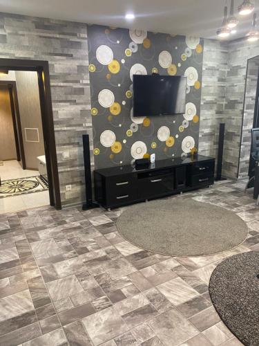 a living room with a flat screen tv on a wall at Appartment Tashkent in Tashkent