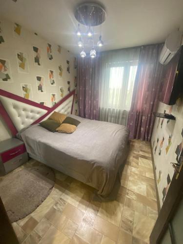 a bedroom with a bed in a room at Appartment Tashkent in Tashkent