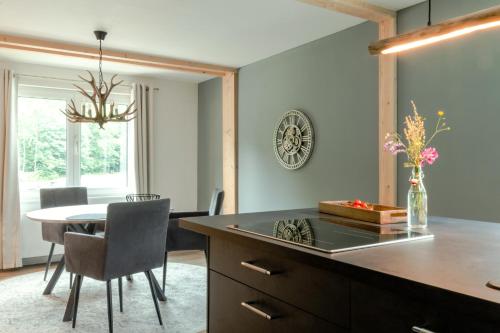 a kitchen with a table and a dining room at Harzfalke Apartment - Ankommen und wohlfühlen. in Wieda