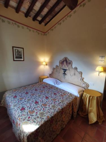 a bedroom with a bed in a room at Villa Borgo San Pietro in Cortona