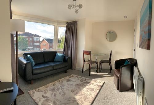 a living room with a couch and a table at Beachside Home - Sleeps 5 Garden Parking & Pets in Skegness
