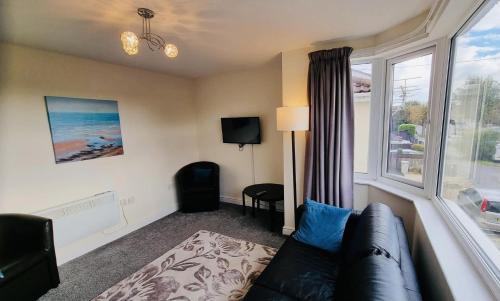 a living room with a couch and a window at Beachside Home - Sleeps 5 Garden Parking & Pets in Skegness
