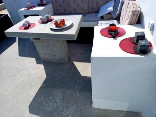 a table with a plate of food on top of it at Tristrato in Parikia