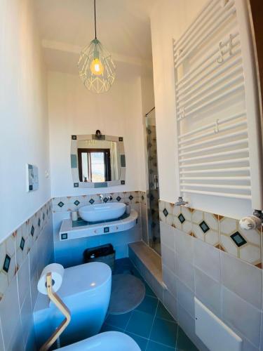 a bathroom with a blue tub and a sink and a mirror at Casa vacanze Da Mammanonna in Taurasi
