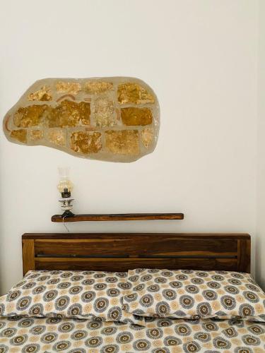 a bedroom with a bed with a stone wall at Casa vacanze Da Mammanonna in Taurasi