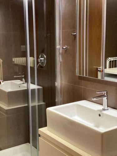a bathroom with a sink and a shower at Suite300 by Palazzina300 in Treviso