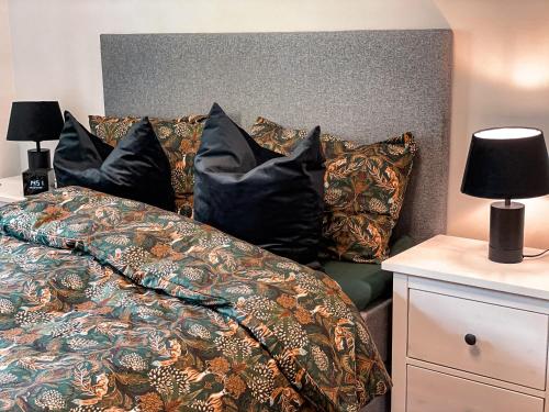 a bed with pillows and a blanket on it at Apartment with 2bedrooms near the train and buss station in Moss