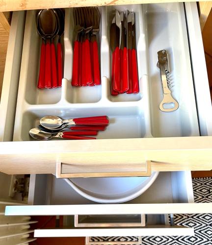 a drawer filled with utensils in a cabinet at Suite300 by Palazzina300 in Treviso