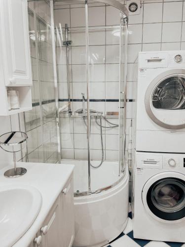 a bathroom with a washing machine and a washer at Apartment with 2bedrooms near the train and buss station in Moss
