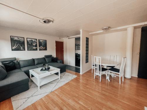 a living room with a couch and a table at Apartment with 2bedrooms near the train and buss station in Moss