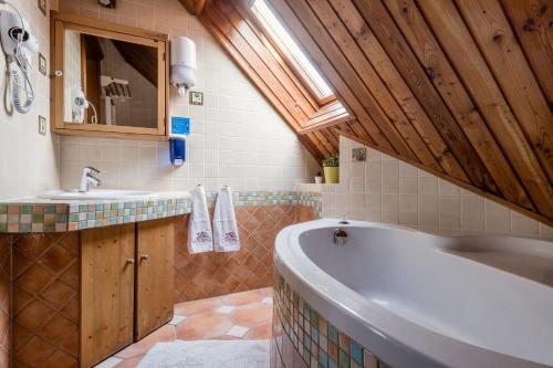 a bathroom with a tub and a sink at Private Villa with indoor pool in Budapest