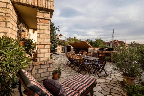 a patio with a table and chairs and a table and chairs at Private Villa with indoor pool in Budapest