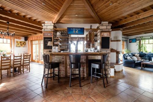 a kitchen and living room with a bar in a house at Private Villa with indoor pool in Budapest