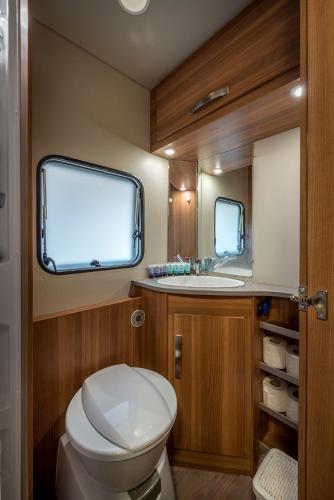 a bathroom with a toilet and a sink at Park Timna in Eilat