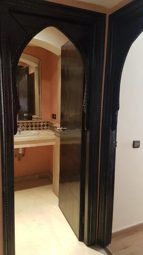 a bathroom with a mirror and a sink in a room at Luxury apartment in the heart of Gueliz , Wifi, Pool in Marrakech