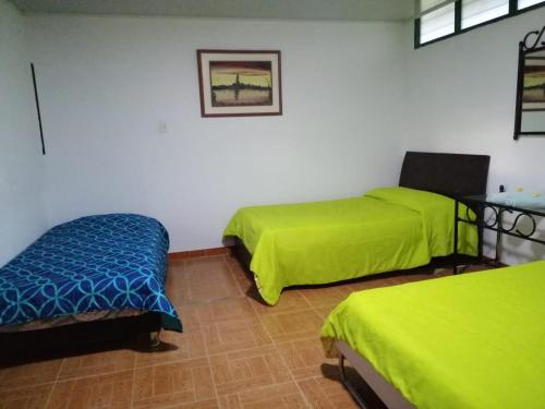 Postel nebo postele na pokoji v ubytování Hospedaje Rancho Guadalupe
